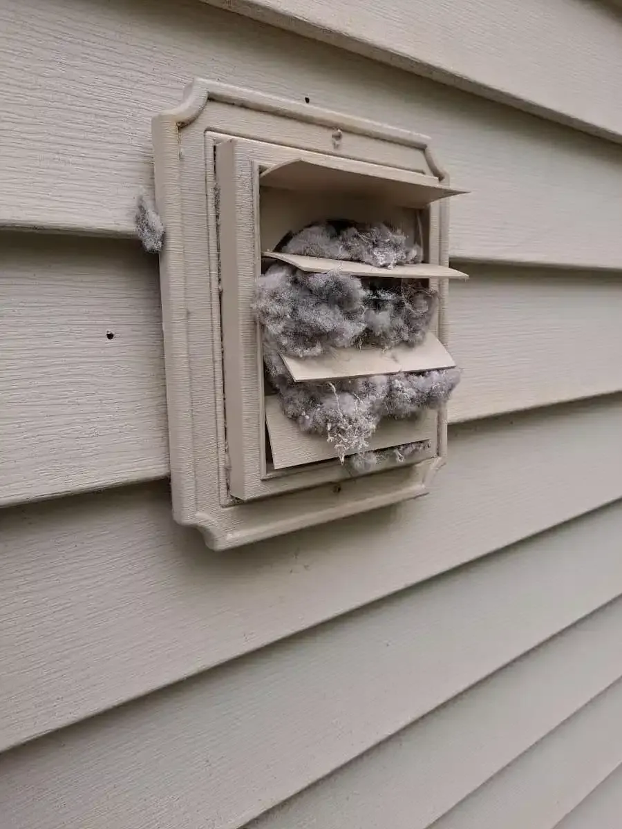 Exterior dryer vent hood packed with lint