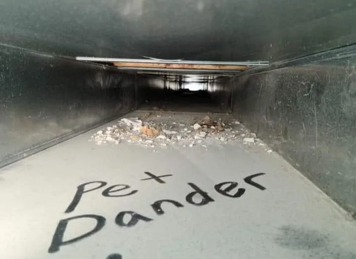 Air duct before cleaning, with debris